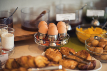 Fresh and bright continental breakfast table with jam. Table settings