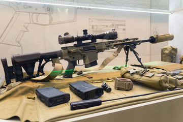 Sniper rifle and accessories on the counter of the store. Weapons - obrazy, fototapety, plakaty