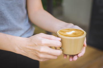 beautiful woman hand hold modern coffe cup for serve hot coffee delicious.