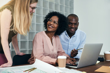 Fototapeta premium Diverse group of smiling colleagues working together in an office