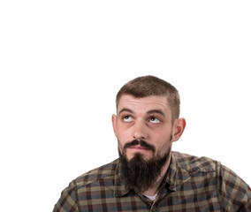 Fototapeta premium Casual man looking up to blank space over white background