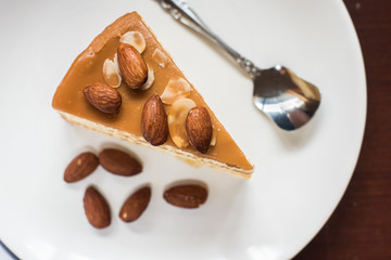 layer cake with almond on top cake in withe dish top view