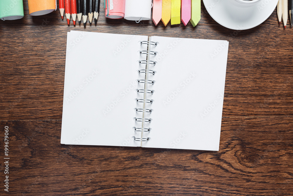 Wall mural Wooden table with notepad and coffee