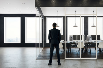 Fototapeta premium Businessman in modern coworking office interior