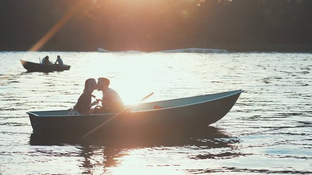 Kissing couple in a boat in sunlight