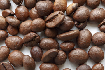 Roasted coffee beans. Isolated on white. Abstract background.
