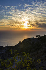 Incredible Turkey, the sunset over the sea, in the sky amazing clouds and an unusual picture of them, in the foreground the road leading to the sea, and to the sea the reflection of the sun