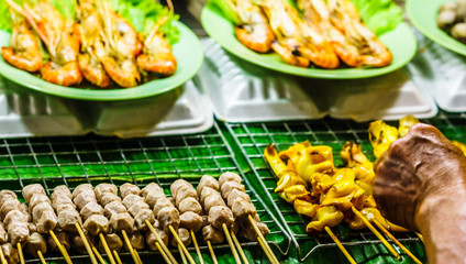 View on barbecue on food market in Chiang Rai - Thailand