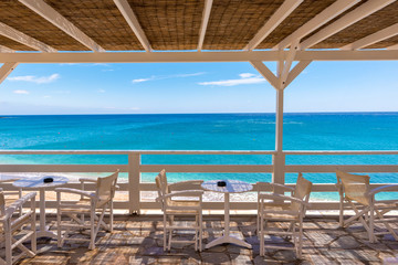 Fototapeta na wymiar Restaurant terrace overlooking the Aegean Sea, Paleochori Beach, Milos. Cyclades Island, Greece.