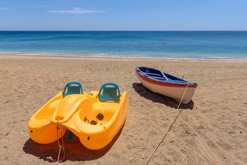 Pedalo with rescue boat on beautiful sandy Paleochori beach on Milos island. Cyclades, Greece.