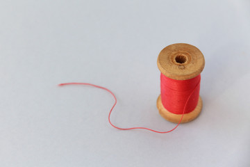 wooden coil with red thread. selective focus