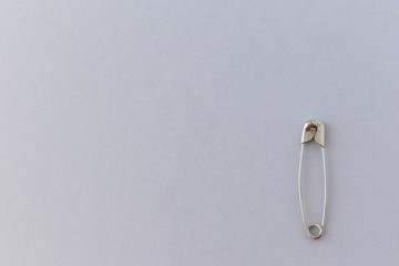 Safety pin on a light background