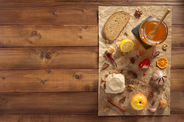 glass jar of honey on wood