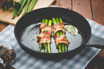 Fresh Young Asparagus Wrapped in Prosciutto Meat and Grilled on pan


