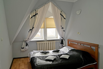 Double bed with a black-and-white cover in the hotel room
