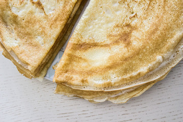 Close up top view of french crepes, thin pancakes on a wooden table