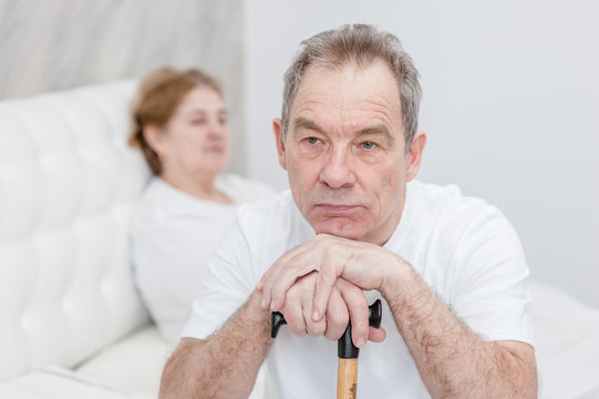 Unhappy Senior Couple Sitting On Bed