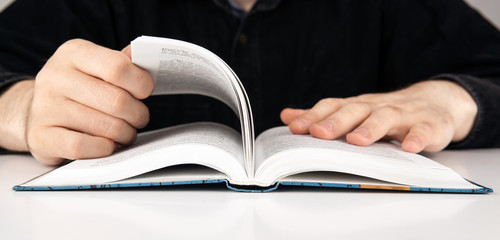 man is looking for information in the dictionary