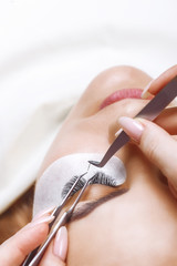 Eyelash Extension Procedure. Woman Eye with Long Eyelashes. Lashes, close up, selected focus. - 199687842
