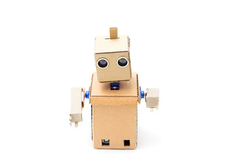 Cardboard robot with hands on a white background. Artificial Intelligence