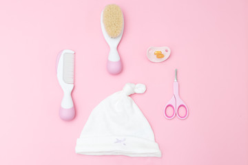 Baby care accessories on pink background. Flat lay