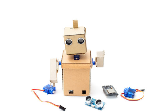 Cardboard robot with hands and different details on a white background. Artificial Intelligence
