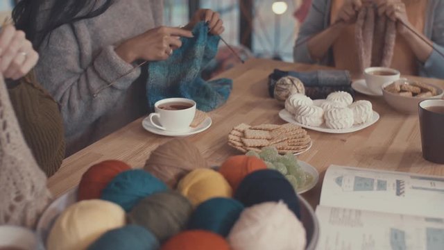 Young girl in a knitting lesson