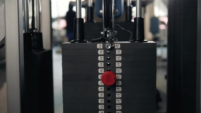 Close up plate stacked of weight machine with kilogram and pound number at fitness gym macro super closeup