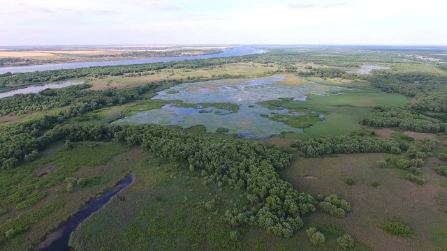 Aerial shot of the Dnipro basin with a wavy inflow, inlets, islets and greenery