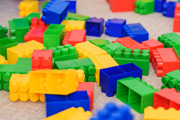 Fototapeta premium The colored bricks of the designer are lying on the floor