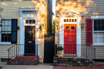 Fototapeta premium Vintage Black and Red Front Doors of two American Colonial Wooden Houses Side by Side in the Historic District of Alexandria, VA