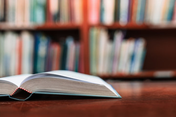 Education learning concept with opening book or textbook in old library, Book in library with old open textbook, Stack piles of literature text academic archive on reading desk in school class room