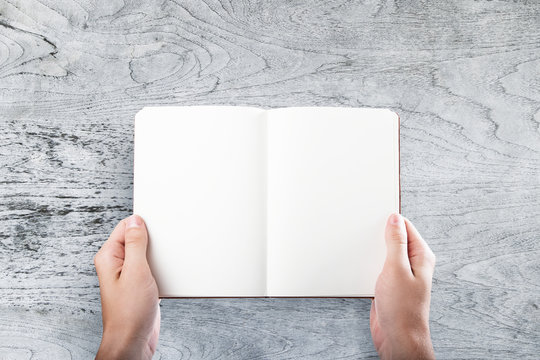 Businessman holding blank book