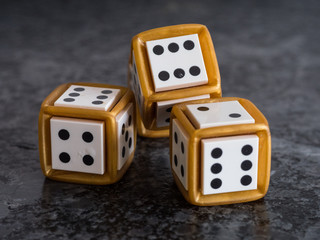 3 golden dices on granite