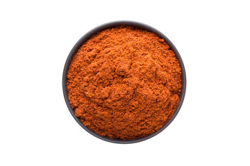 chili powder in clay bowl isolated on white background. Seasoning or spice top view