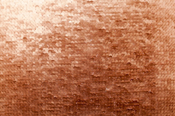 Sequins close-up macro. Abstract background with gold sequins color on the fabric.