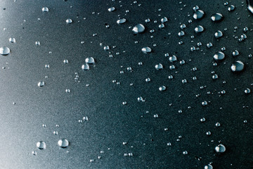 Drops of water on black table.