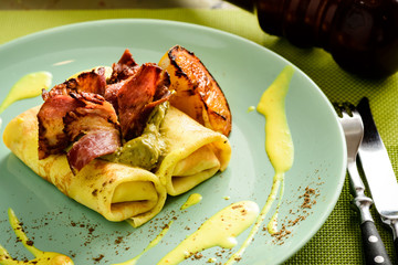 Delicious pancake blinis with bacon and mustard sauce. New restaurant menu for the holiday Maslenitsa
