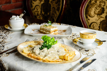 Sweet delicious pancake blini with sauce at the table. New restaurant menu for the holiday Maslenitsa