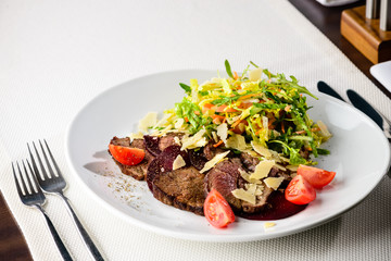Juicy beef steak with vegetables salad in a restaurant