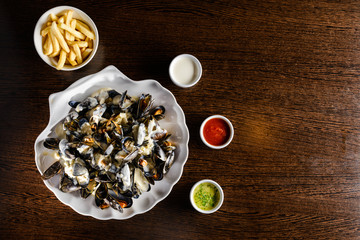 Delicious Shellfish Traditional Mussels with sour cream sauce on the table with copyspace for text. Top view, flat lay