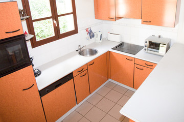 Fototapeta na wymiar New modern orange kitchen interior