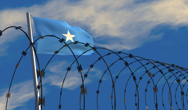 3D illustration of a Somali flag waving on a flagpole with razor wire in the foreground; depicting security and barriers between nations. 