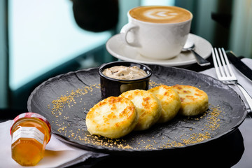 Sweet cottage cheese pancakes baked in the oven. Russian dessert syrniki