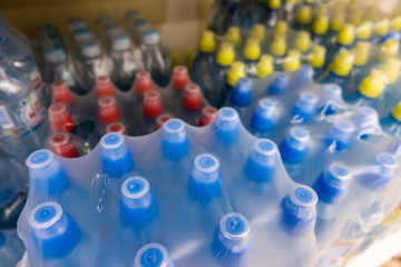 Fototapeta premium PET Bottles. Image of many plastic bottles with water in a shop. plastic bottles with drinking water top view. 