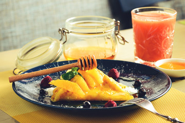 Sweet delicious pancake blinis with curd, honey and berries, toned image. New restaurant menu for...