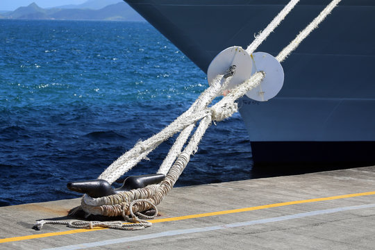 mooring lines with rat guards attached to cleat on pier, Lesser Antillies, Caribbean