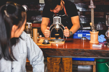 Makeing prepares coffee for customer