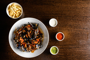 Delicious Shellfish Traditional Mussels with tomato sauce on the table with copyspace for text. Top view, flat lay