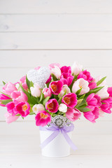 Pink tulip on the white background. Easter background